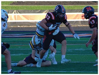 A group of football players on a field. Description generated by AI