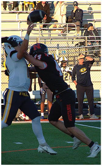 A football player catching a ball. Description generated by AI