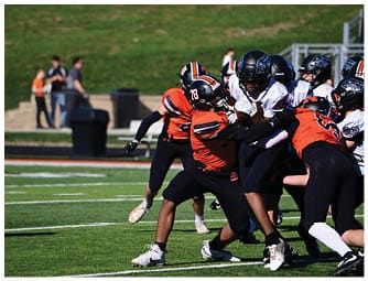 A group of football players on a field. Description generated by AI