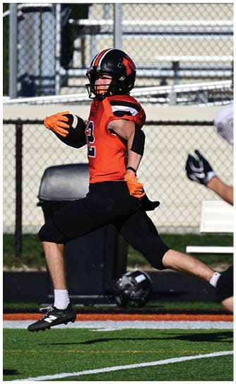 A football player catching a ball. Description generated by AI