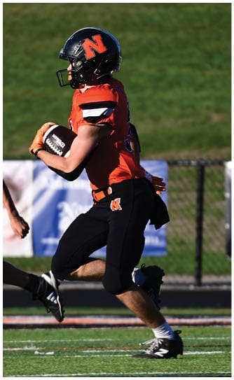A football player catching a ball. Description generated by AI