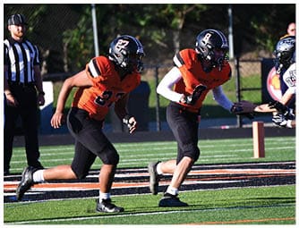 A group of football players on a field. Description generated by AI