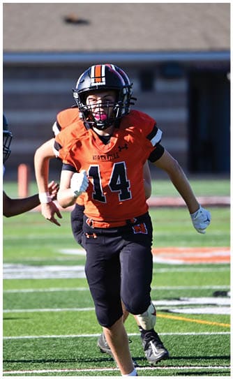 A football player catching a ball. Description generated by AI
