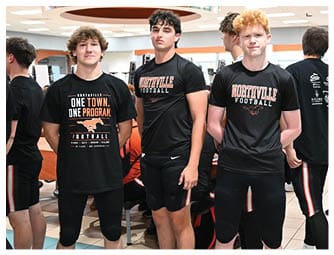 A group of football players on a field. Description generated by AI