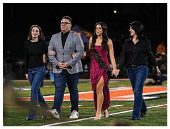 A group of football players on a field. Description generated by AI