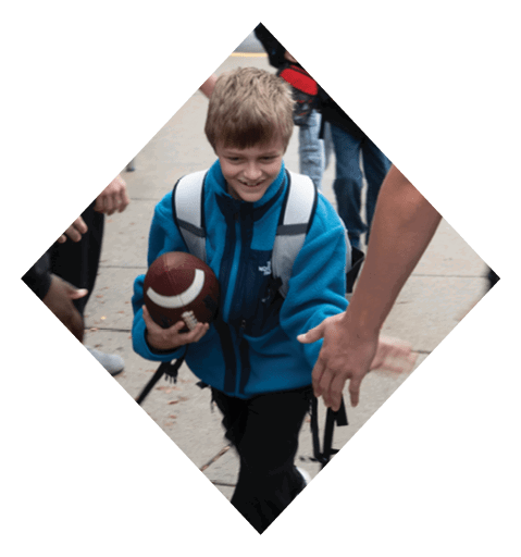 A female football player is kicking a football on a field. AI generated content