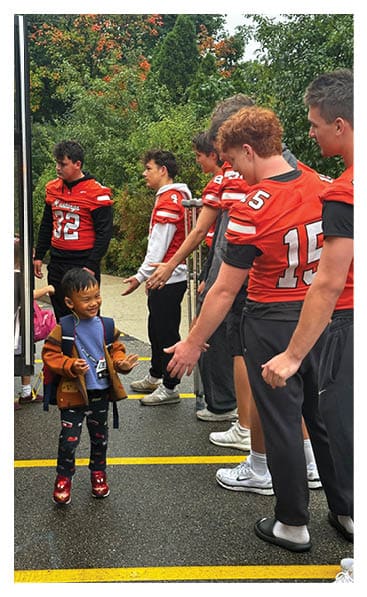 A young man wearing a football jersey with the name Vista on the back. AI generated content