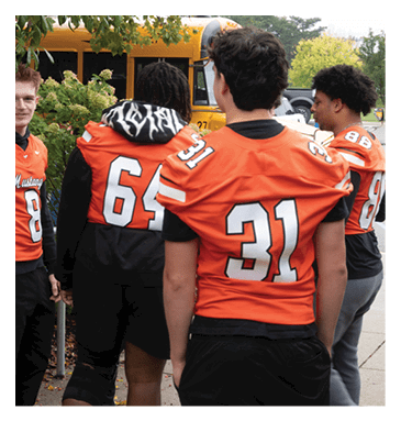 A football player in a white jersey with the number 85 on it is trying to catch a football. AI generated content