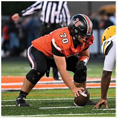 A football player running on the field. Description generated by AI