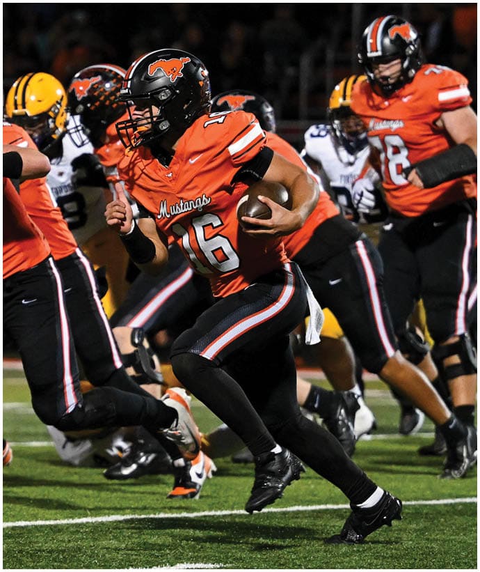 A group of football players wearing black and white uniforms. Description generated by AI