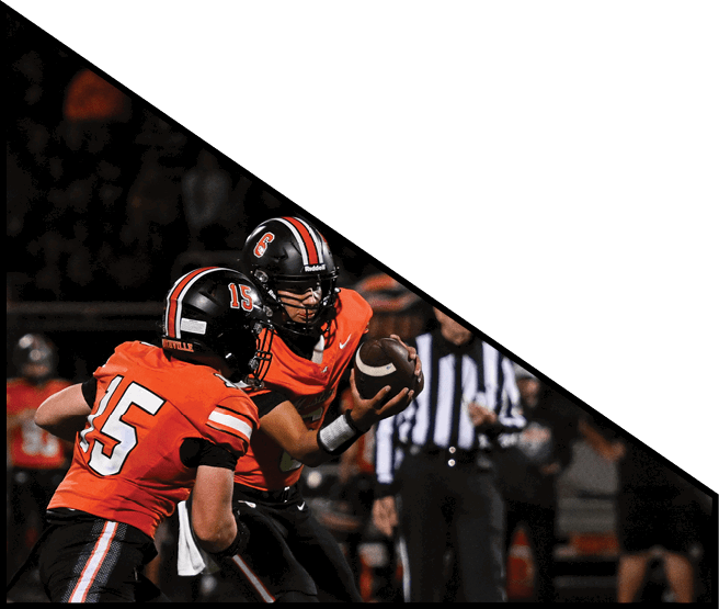 A group of football players kneeling on the field, some with their hands on their heads. AI generated content