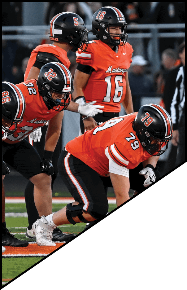 A football player is kneeling on the field, holding his helmet in his hands. AI generated content