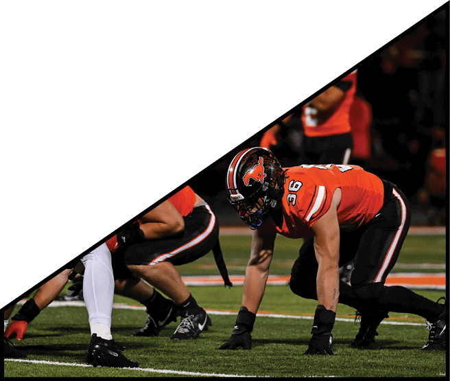 A group of football players kneeling on the field, some with their hands on their heads. AI generated content