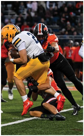 A football player is sliding on the ground. Description generated by AI