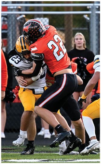 A football player is sliding on the ground. Description generated by AI