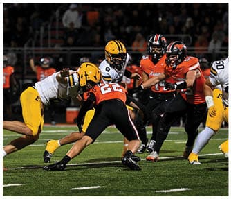A group of football players wearing black and white uniforms. Description generated by AI