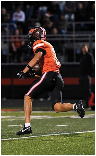 A football player is sliding on the ground. Description generated by AI