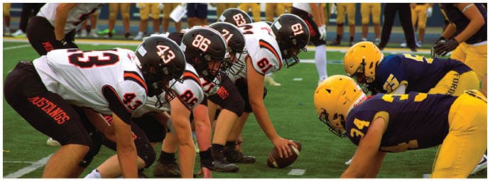 A football player wearing a blue and white uniform. Description generated by AI