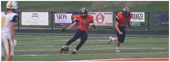 A football player wearing a blue and white uniform. Description generated by AI