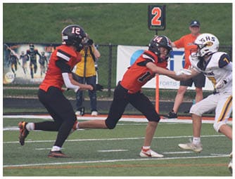 A group of football players on a field. Description generated by AI