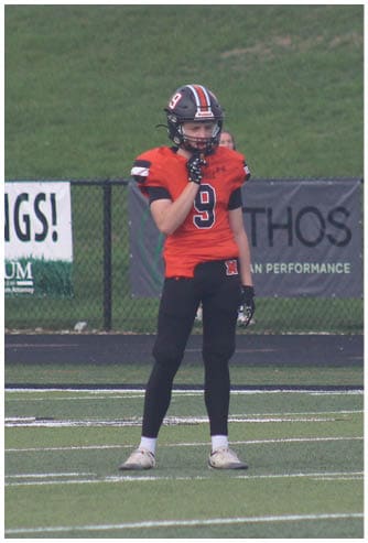 A football game is being played on a field. Description generated by AI