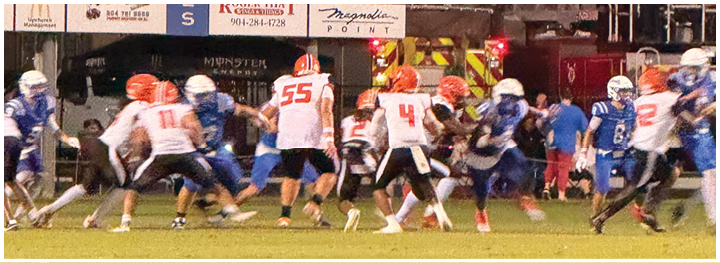 A football player is sliding on the ground. Description generated by AI