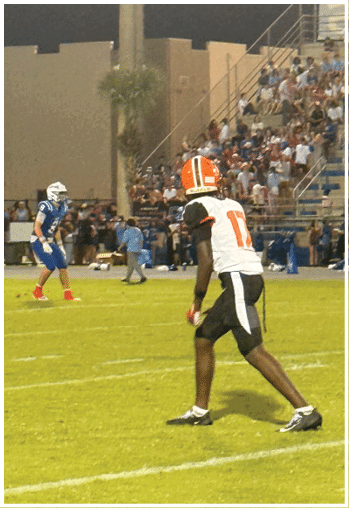 A football player running on the field. Description generated by AI