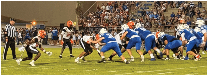 A football player is sliding on the ground. Description generated by AI