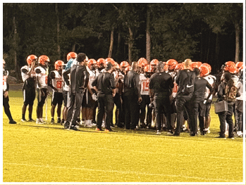A football player is sliding on the ground. Description generated by AI