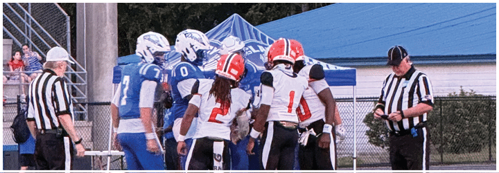 A group of football players on a field. Description generated by AI