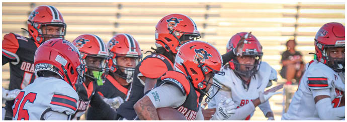 A group of football players on a field. Description generated by AI