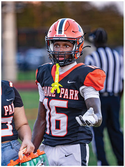 A football player wearing a blue and white uniform. Description generated by AI