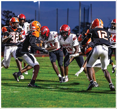 A group of football players huddled together on the field. Description generated by AI
