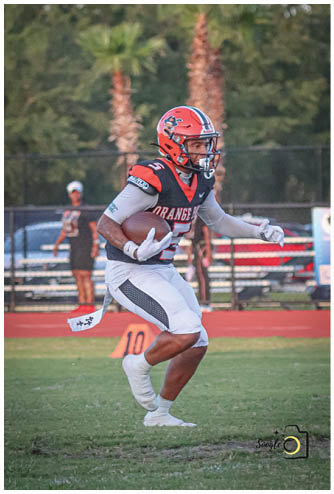 A football player running on the field. Description generated by AI