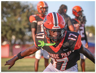 A football player is sliding on the ground. Description generated by AI