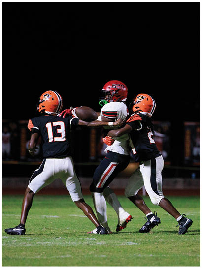 A football player wearing a blue and white uniform. Description generated by AI