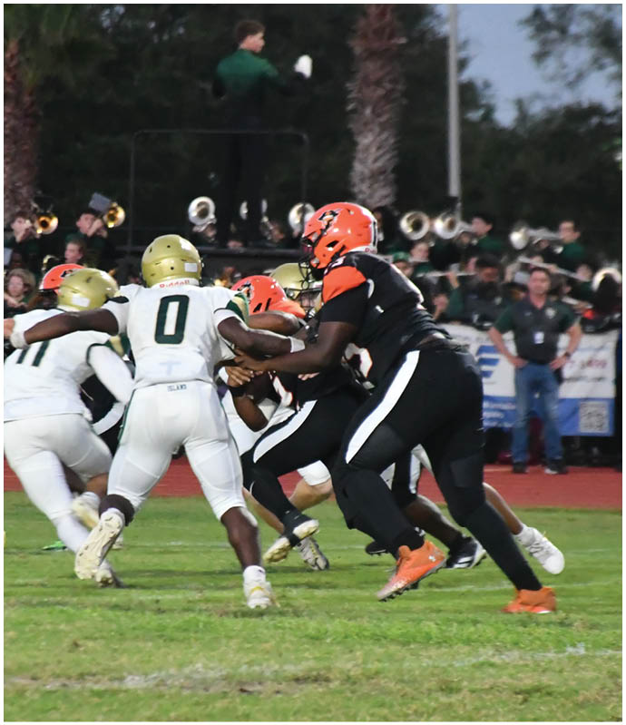 A group of football players wearing black and white uniforms. Description generated by AI