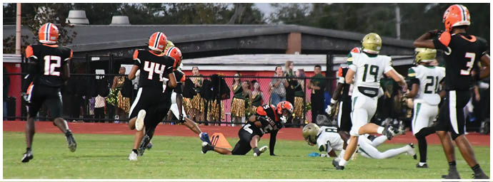 A football player is sliding on the ground. Description generated by AI