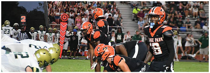 A group of football players on a field. Description generated by AI