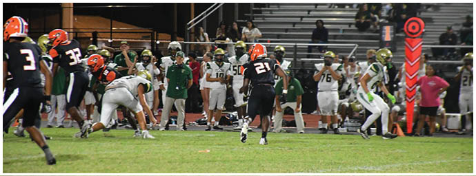 A football player is sliding on the ground. Description generated by AI