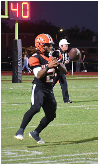 A football player running on the field. Description generated by AI