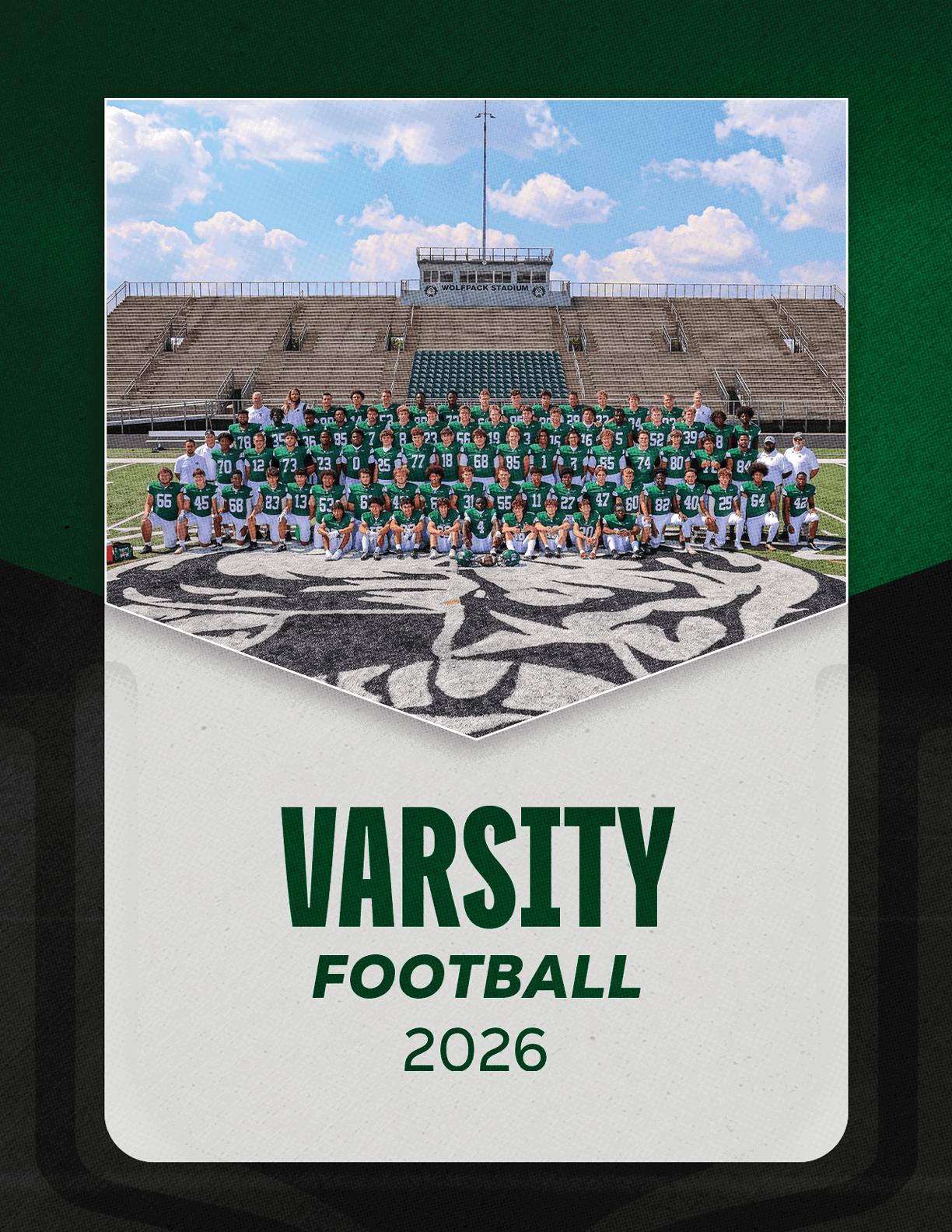 A large group of people in green and white football uniforms pose together on a football field with empty bleachers in the background and the text varsity football 2026 below. Description generated by AI