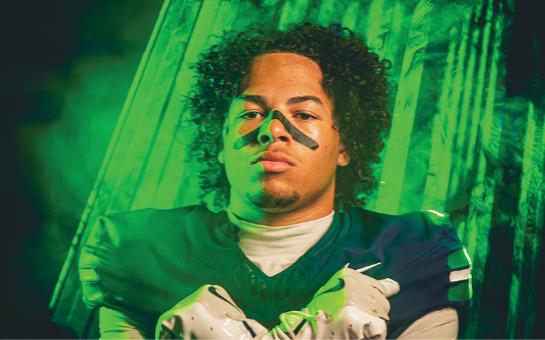 A football player wearing a blue and white jersey with the number 11 on it. Description generated by AI