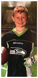 A football player wearing a blue and red jersey. Description generated by AI