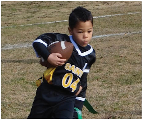 A football player wearing a blue and red jersey. Description generated by AI