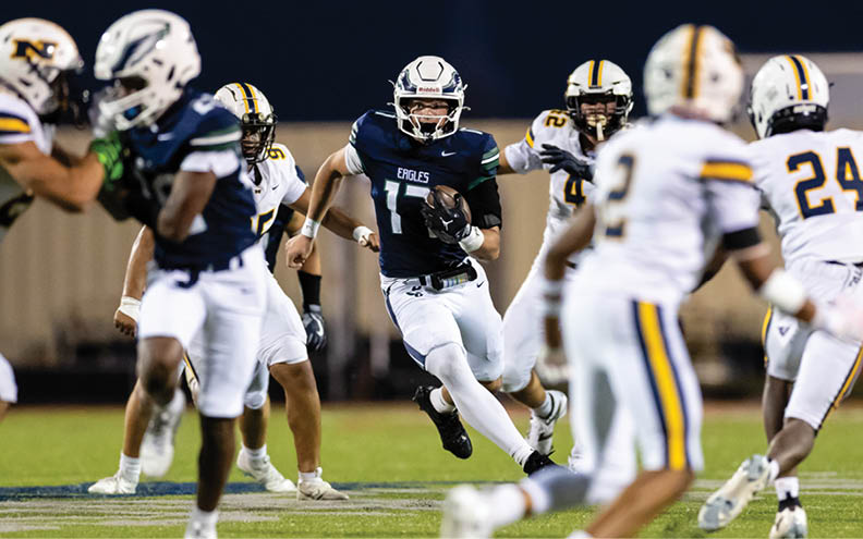 A football player wearing a blue and white jersey with the number 11 on it. Description generated by AI