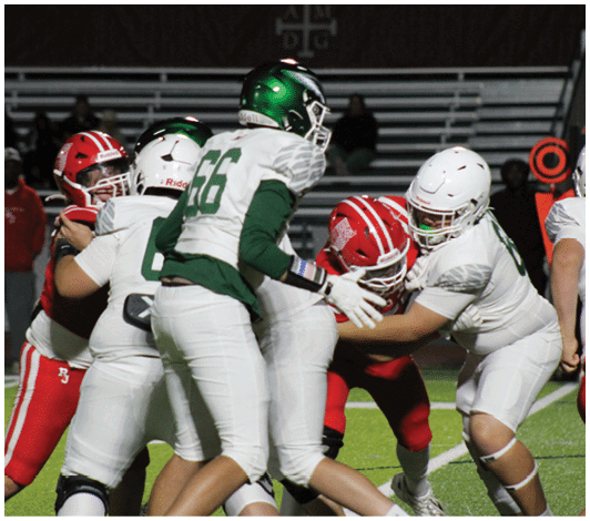 People wearing football uniforms are engaged in a play on a football field with some players in white and green and others in red. Description generated by AI