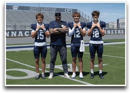 Three football players are standing on the field, one of them is smiling and wearing a black jersey with the number 55. AI generated content