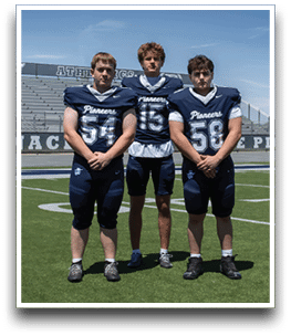 Three football players are standing on the field, one of them is smiling and wearing a black jersey with the number 55. AI generated content
