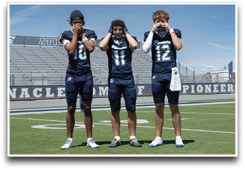 Three football players are standing on the field, one of them is smiling and wearing a black jersey with the number 55. AI generated content